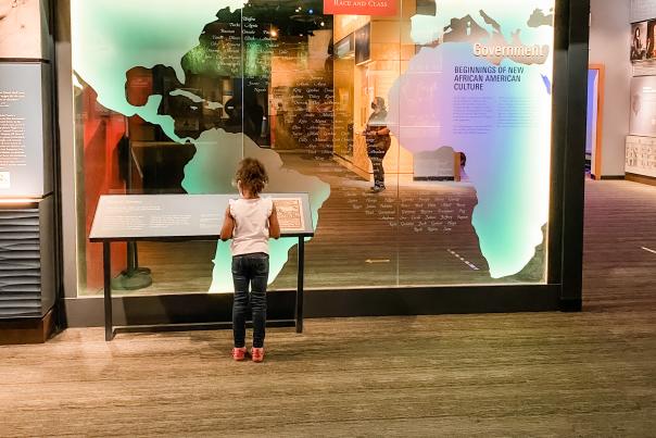 Little girl in front of "Slavery in Virginia" exhibit