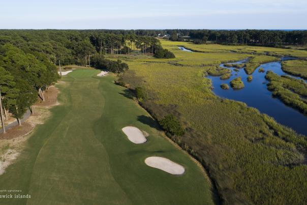 Pearl Golf Club golf course fairway aerial view with blue water feature and greenery.