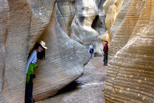 Hikers explore a stunning slot canyon in Grand Staircase-Escalante National Monument.
