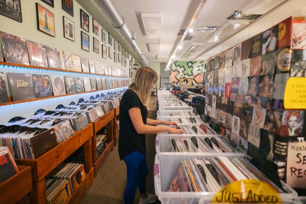 visitor shopping the vinyl music selection available at Black Hills Vinyl in downtown rapid city, sd