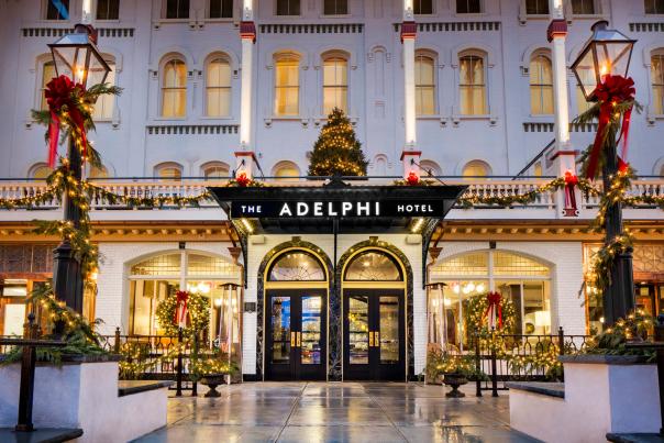 Front of the Adelphi with tiny white lights, decorated lamp posts, wreaths and tree