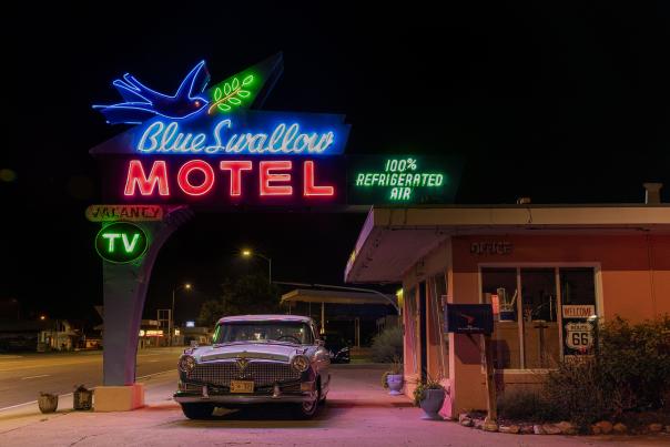 Blue Swallow Motel's neon sign lit up at night in Tucumcari.