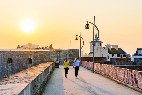 Photograph of two people walking on the fortifications of Old Portsmouth