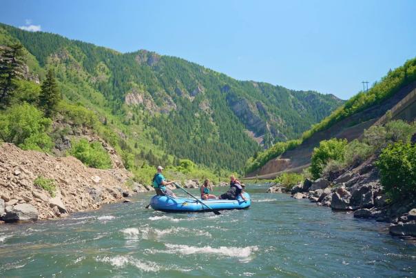 inflatable raft floating down scenic Provo River