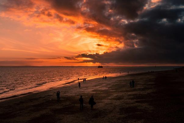 Photograph showing a fiery red sky over the Southsea Beach at dusk