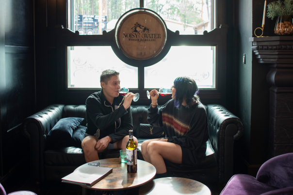 Couple drinks wine in Noisy Water Winery's tasting room.