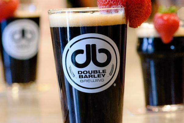 Double Barley Brewing dark beer with a strawberry, located in Johnston County, NC.