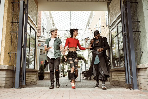 Three friends having fun walking and talking.