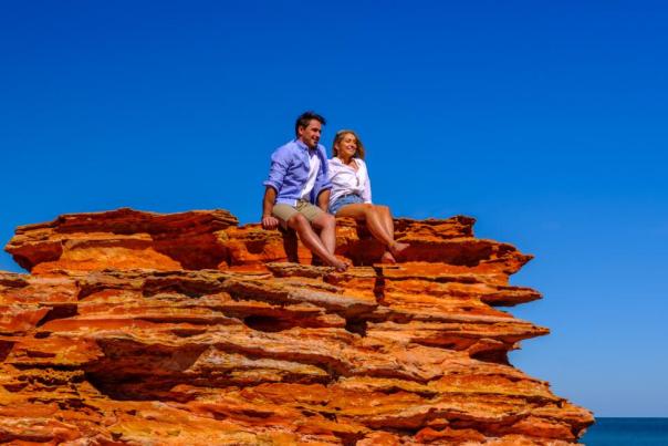 Couple sitting on a rock Broome
