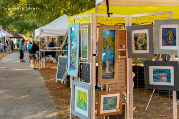 paintings for sale at an outdoor festival