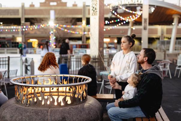 family roasting marshmellows at main street square in downtown rapid city, sd