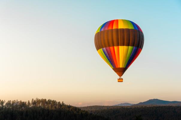 Black hills balloon stour hot air balloon taking flight with the sunrise over the black hills of south dakota