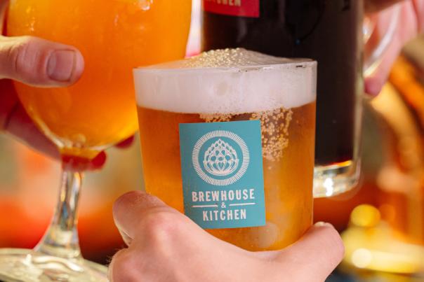 Three hands holding beers in a cheers