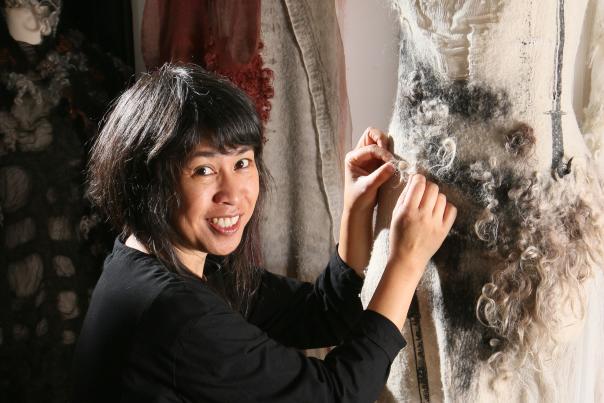 Designer Celeste Malvar-Stewart works on a dress made of sustainable fabrics