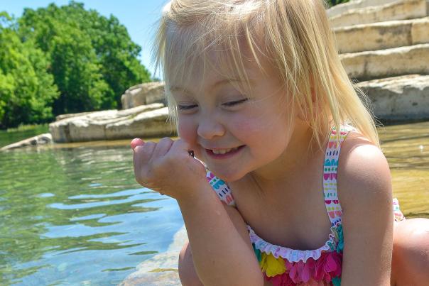 Little girl excited to play in the San Marcos River