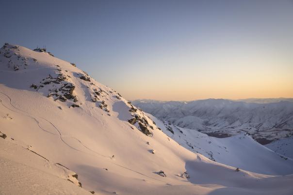 Far shot of person skiing at the Remarkables ski aera at sunrise
