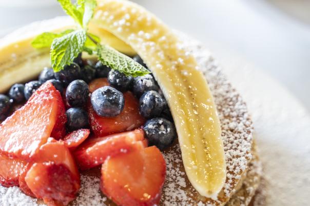 Protein Packed Buttermilk Pancakes topped with fresh fruit from Hash Kitchen in Chandler, AZ