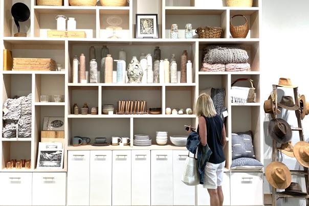 A woman browses in front of shelves at Common Good Co.