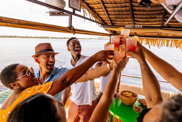 Friends toasting aboard the Oasis Tiki Boat in Charlotte Harbor, Florida
