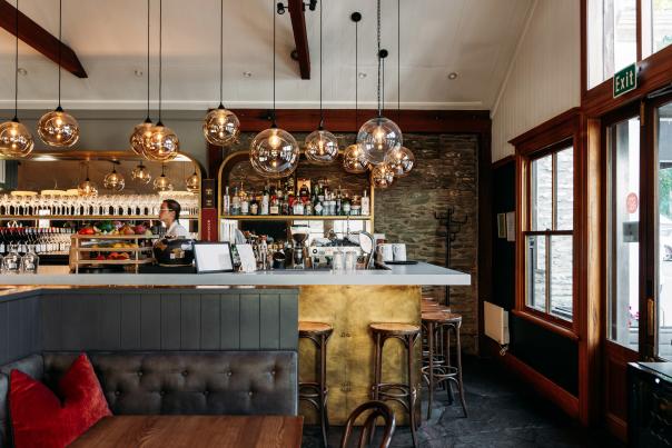 Interior shot of Aosta Restaurant - modern design with liquor bottles in the background