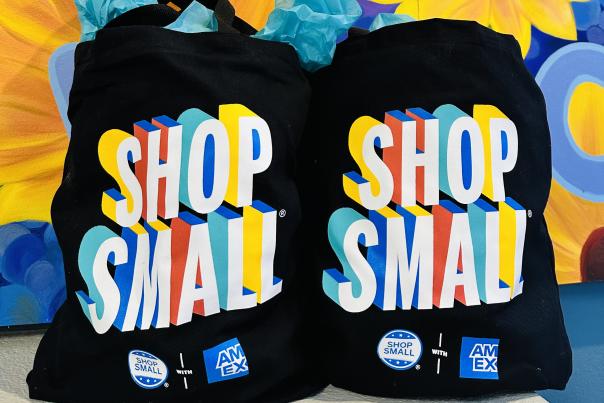 Shop Small bags in front of a colorful mural