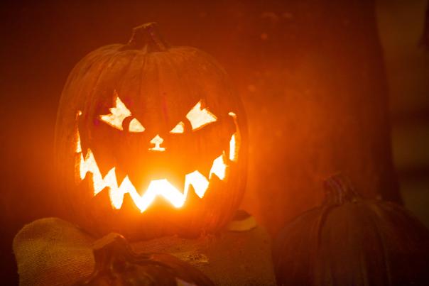 Picture of a scary pumpkin at night with a glowing mouth