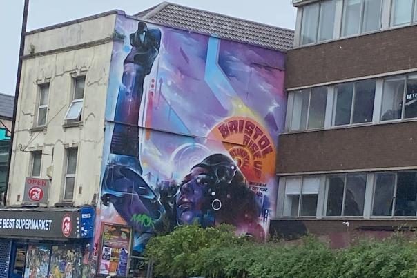 A rundown building in Bristol showing graffitti artwork of Jen Reid