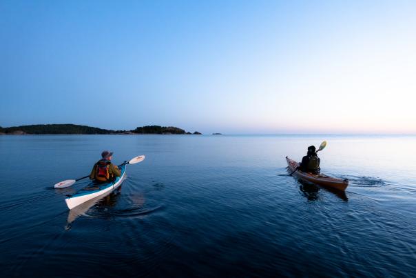 Kayakers paddling near Presque Isle at sunrise