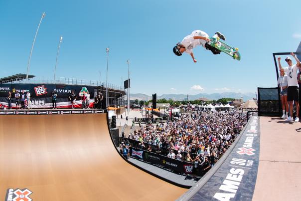 A skateboarding doing tricks infront of a crowd in sacramento