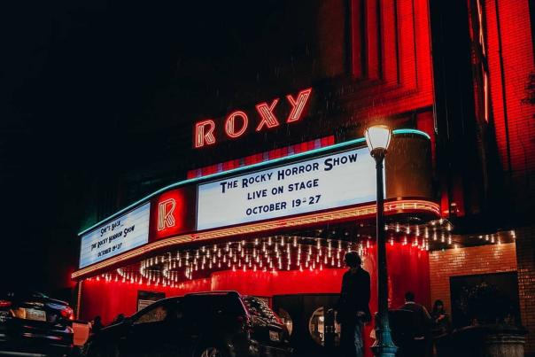 art deco theatre lit at night