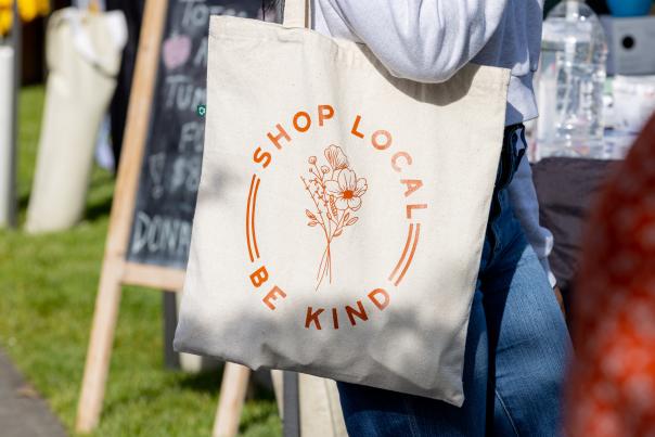 Shopping bag that reads Shop Local, Be Kind