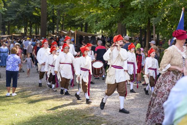 Children's band marching through the Johnny Appleseed Festival in period-authentic clothing