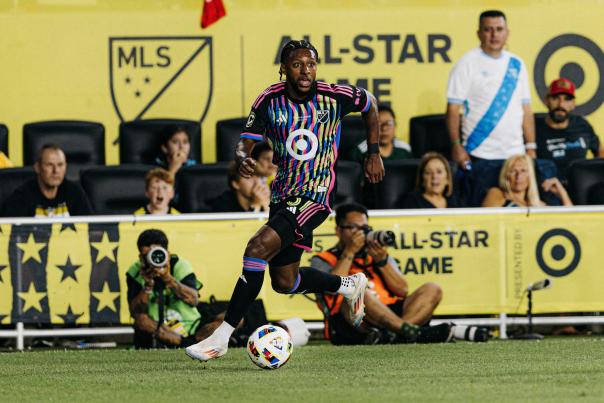 Columbus Crew player runs with ball on field during MLS All-Star game