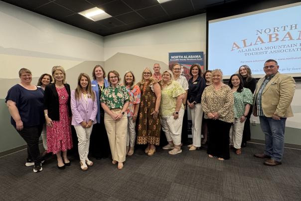 Staff members at Cook Museum of Natural Science and Alabama Mountain Lakes Tourist Association pose inside the Cook Museum