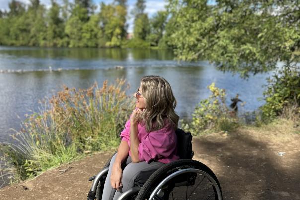 Kristin looking out over Delta Ponds, wheeled up to the edge on compacted dirt.