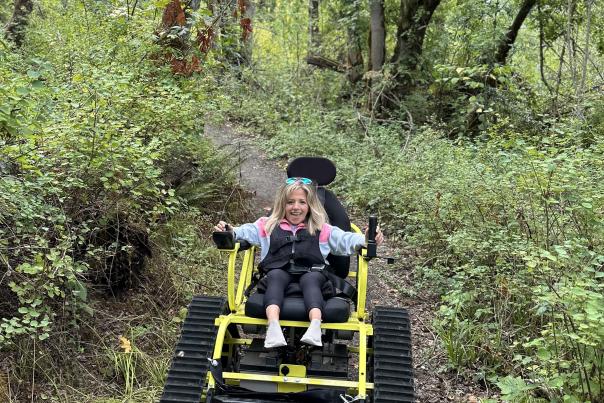 Kristin navigates a leafy trail using a track chair at Mt Pisgah.