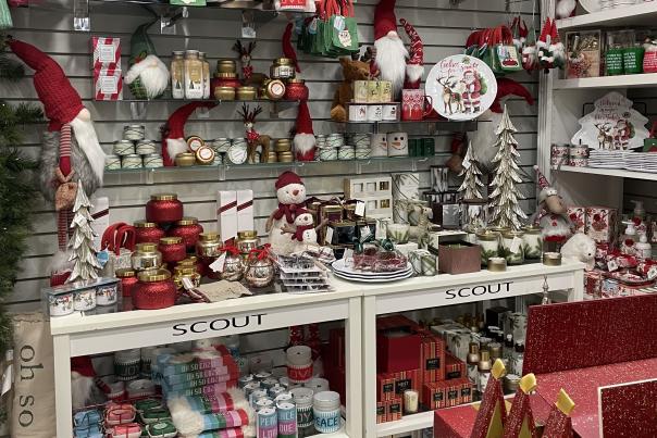 A local shop displays holiday tees and decor for Christmas