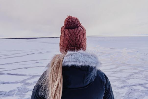 a woman looking out over an icy Lake Superior near Marquette, Michigan
