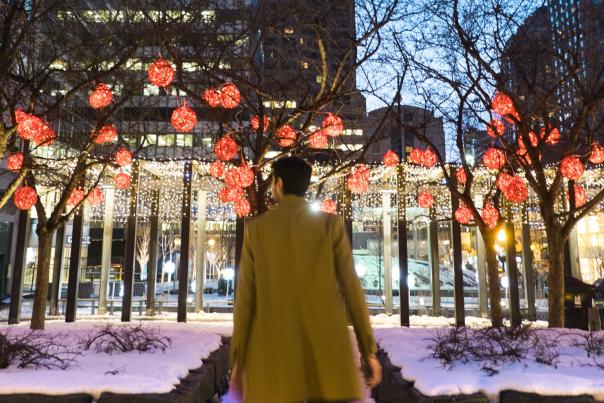 A person walking through twinkling lights in Toronto's Yorkville neighbourhood
