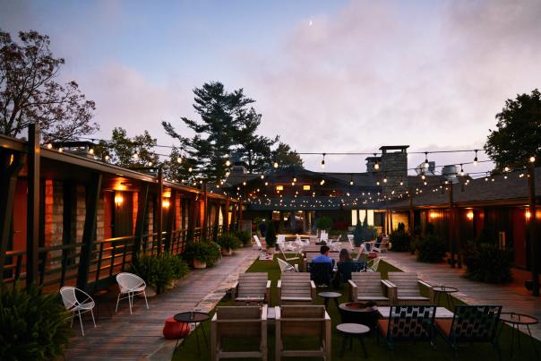 The large deck of Skyline Lodge at dusk with string lights hanging above.