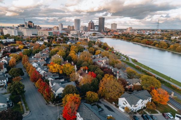 An image of the City of Rochester f5rom above surrounded by autumn leaves