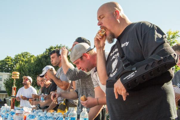 Participants try to eat the most hamburgers at Taste of Hamburger Fest competition.
