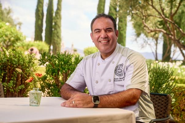 Photo of Executive Chef Amin Boubaddi sitting down at a table.