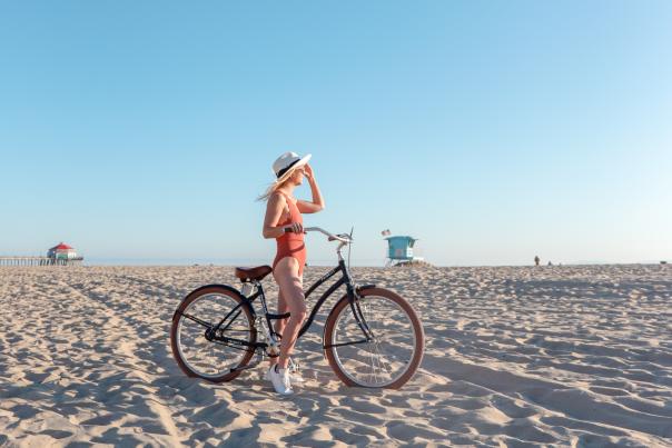 Biking riding at Huntington Beach | Girl on her bike with the Huntington Beach Pier in the background