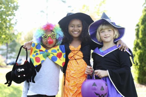 three young girls posing in their Halloween costumes