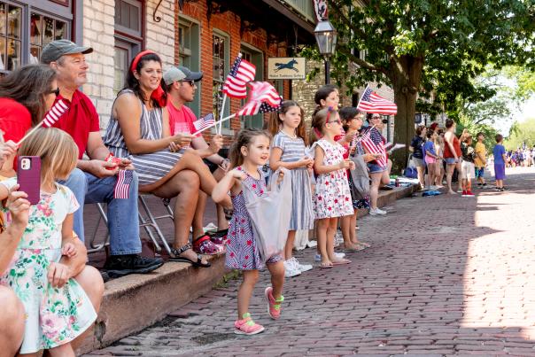 Kids waving flags at Riverfest Parade