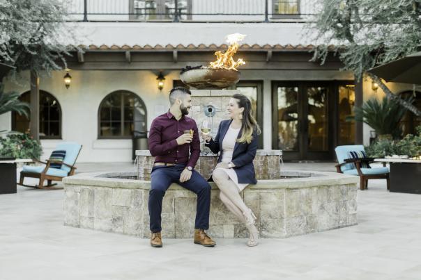 Couple enjoy wine on a romantic patio at Rancho Las Palmas Resort