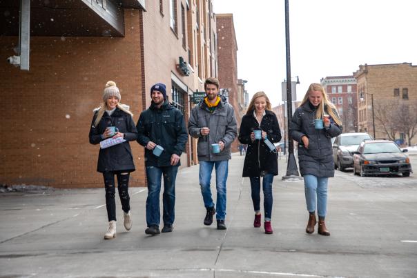 Group walking downtown during the Coffee & Cocoa Crawl.
