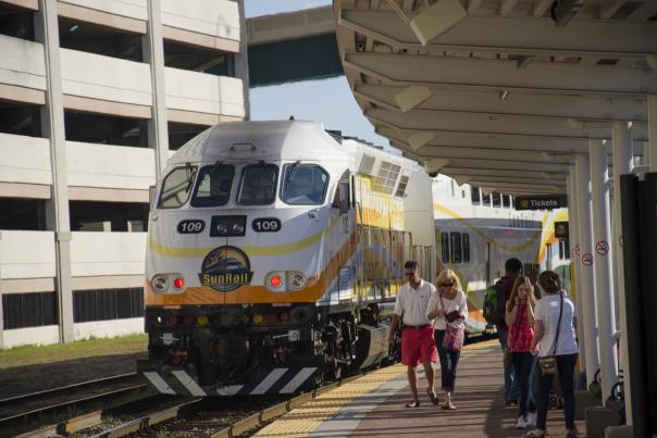 A SunRail train arrives at a station in downtown Orlando