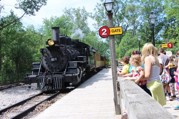 Families watch the Huckleberry Railroad engine approach at Crossroads Village.